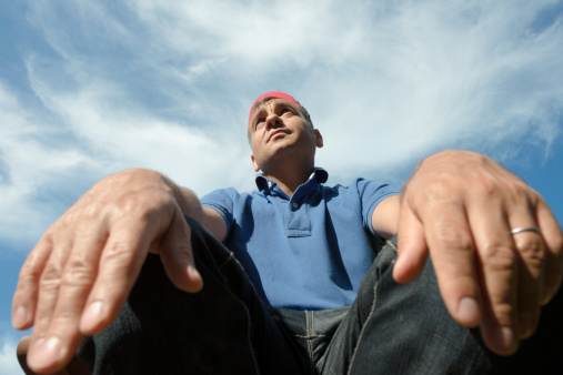 Portrait photo of a Turkish man wide angle lens and low angle view.