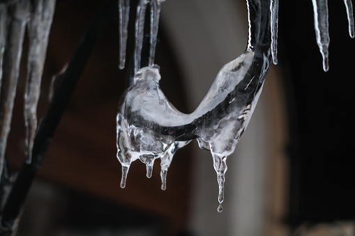 Hanging icicles on the roof of a house