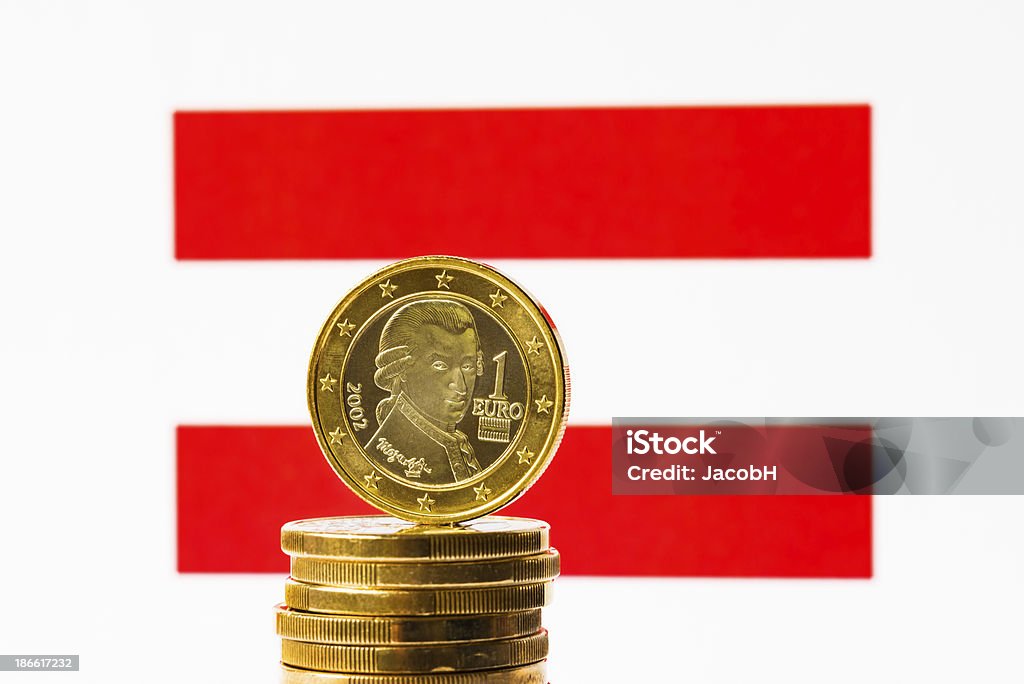 Austrian Flag and Euro Close-up of an Austrian flag and Austrian euro coin. Focus is on the euro coin. Austria Stock Photo