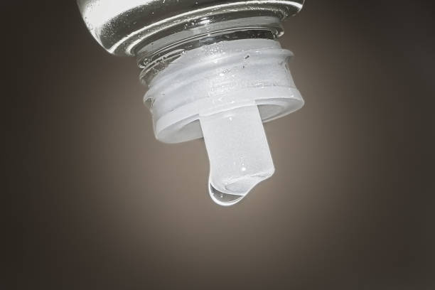 Topical oil dripping from the bottle, drops of topical oil dripping from the bottle