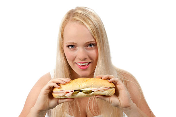 istock Young woman eating sandwich 186619102