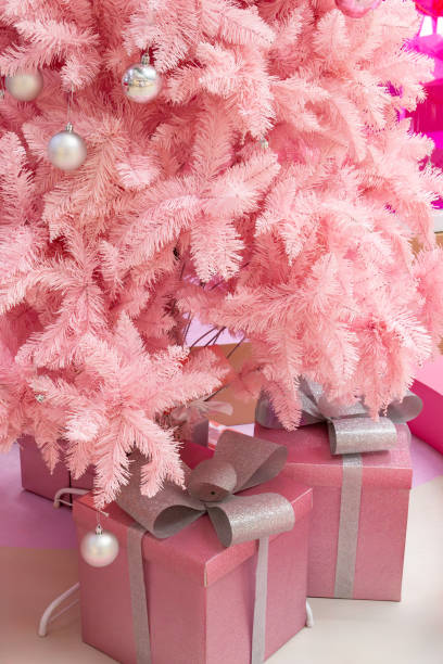 istock part of a pink Christmas tree with gift boxes at vertical composition 1866206627