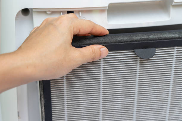 istock Close up on hand to remove old air purifier filter (Hepa filter) with dust on it. 1866212810
