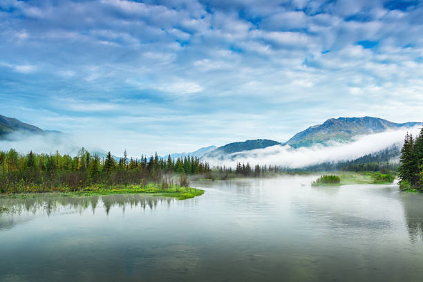 Lake and mountain landscape with early-morning fog stock photo