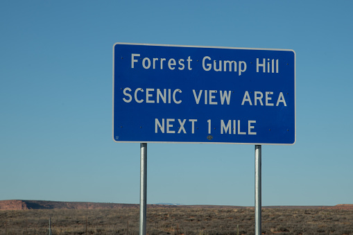 Highway sign marks the spot where favorite story character Forest Gump ended his run on highway to Navajo Indian Monument Valley where many western movies were made.