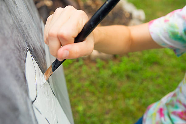 istock Young Woman Painting 186621919