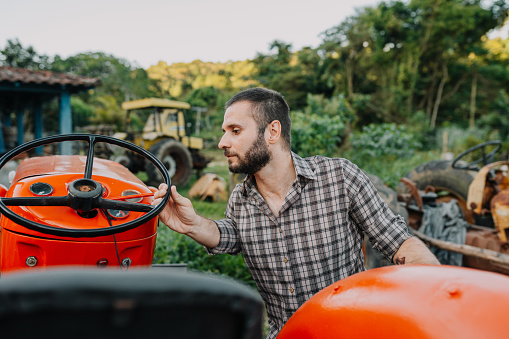 Farmer checking out renovated tractor