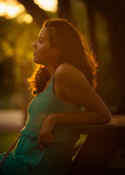 Beautiful and young ginger hair woman side portrait on the river bridge.