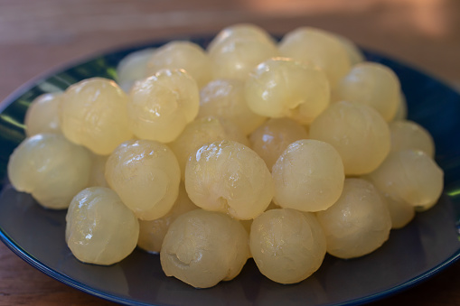 Fresh Longan, Dimocarpus longan meat was removed from longan bark in a white blow, Thai fruit. cooking concept.