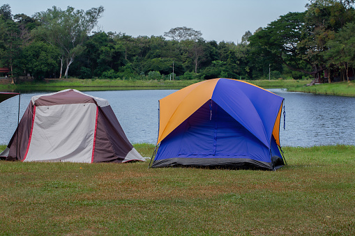 Camping and tent on Lawn or green grass ground in morning, vacation picnic on holiday relax, Camping season