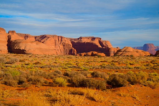 The Monument Valley in UtahArizona state with the red earth desert and rock in the background that looks like a sleeping dragon - The valley is considered sacred by the Navajo Nation - USA