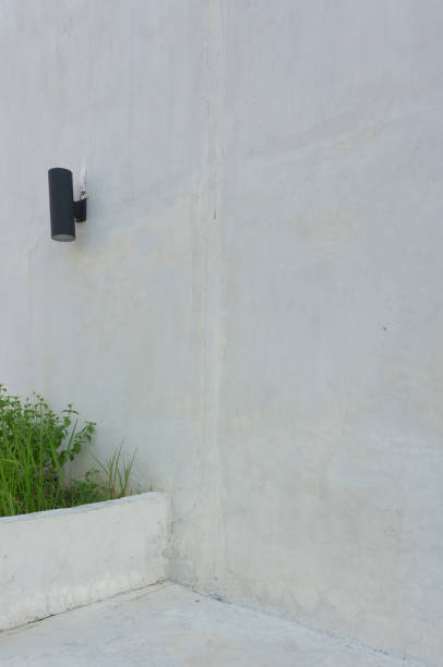 Empty space or copy space of white wall with a black lamp