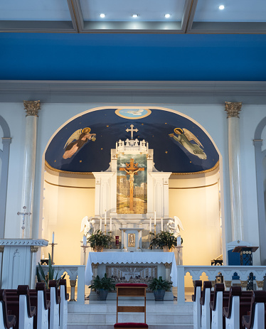 View of the sanctuary, altar and artwork in the historic Immaculate Conception Catholic Church in Jefferson, Texas.