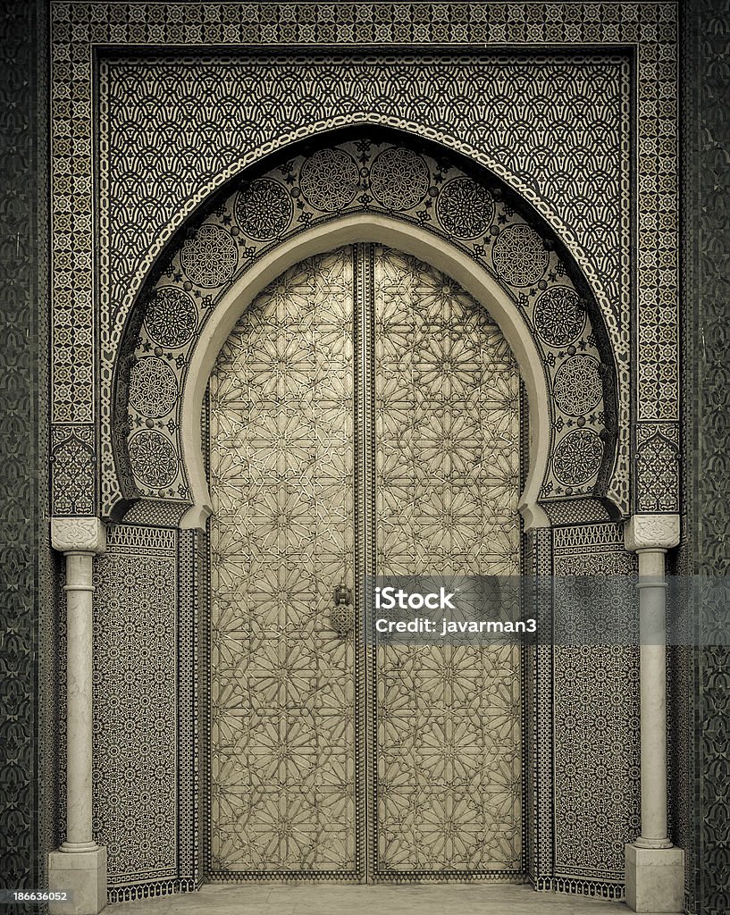 Ancient gold doors and grey portico in Morocco Ancient doors, Morocco Door Stock Photo
