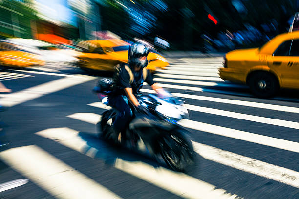 beschleunigung yellow taxi und motorrad in new york city - people traveling business travel travel new york city stock-fotos und bilder