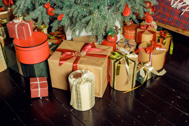istock Christmas background with many gift boxes decorated with ribbon on floor under Christmas tree. Winter holidays concept. stack of Boxes with gifts under the Christmas tree 1866439493