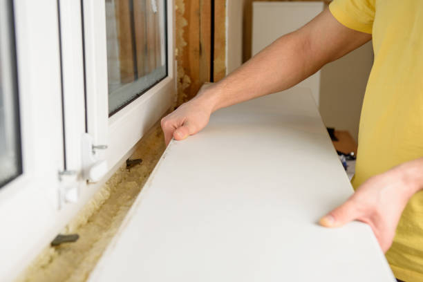 istock A man installs a window sill to a new window 1866478453