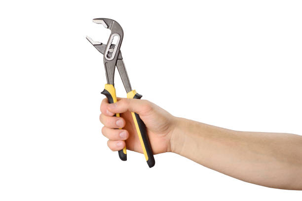 istock Hand holds adjustable pliers to repair something. Isolated object on white. Do it yourself 1866478493