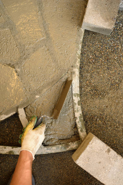 istock A man makes paving slabs from cement mortar using a form and a trowel 1866478506