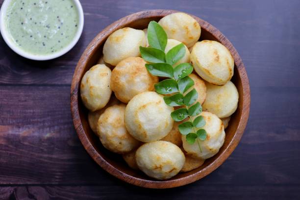 Paniyaram are savory balls made using fermented rice and urad dal batter along with tempered onion and spices. Also known as Paddu, Ponganalu, Kuli, bugga, and appe. served with coconut chutney