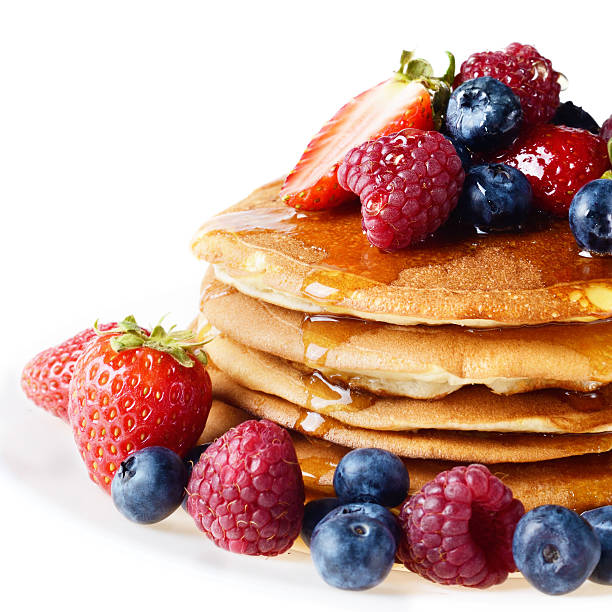 istock Pancakes with berries and honey over white 186652227