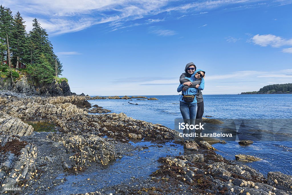 Womens Bay Happy mother is embraced by son in the moment of walk at the seaside. Kodiak island , Alaska. Alaska - US State Stock Photo