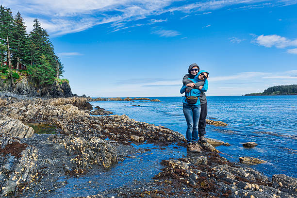 Womens Bay Happy mother is embraced by son in the moment of walk at the seaside. Kodiak island , Alaska. kodiak island photos stock pictures, royalty-free photos & images