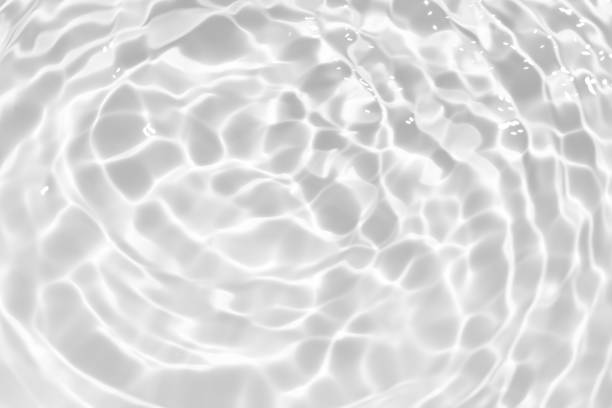 istock White water with ripples on the surface. Defocus blurred transparent white colored clear calm water surface texture with splashes and bubbles. Water waves with shining pattern texture background. 1866573172