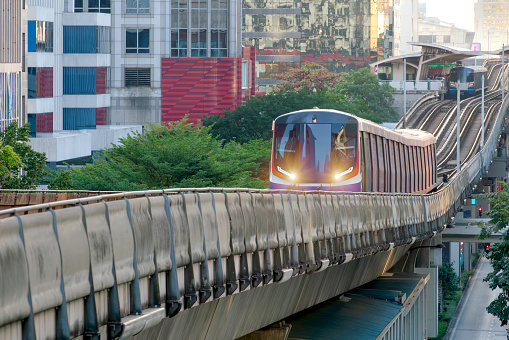 Elevated view of Metro train arrive to station on evening  in Sukhumvit,bangkok Thailand