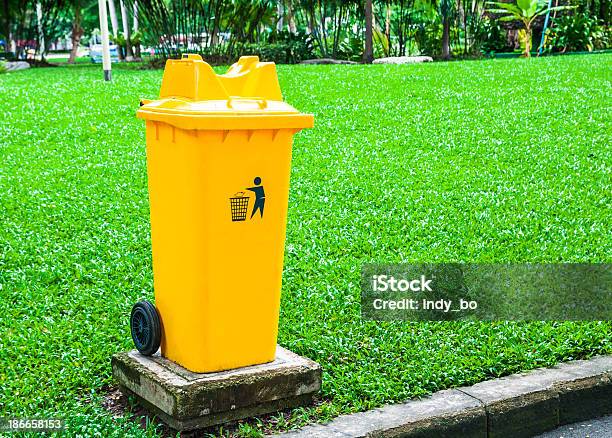 Trash Can Yellow In Park Stock Photo - Download Image Now - Arranging, Asphalt, Can