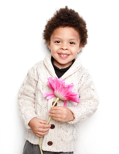 Cute child smiling with big pink flower