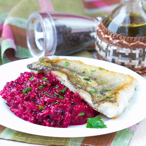 Fried fish fillet of perch with mashed beet and potato stock photo