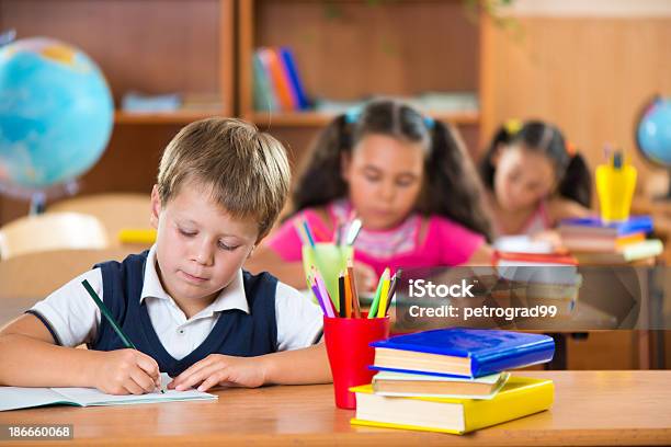 Schoolchildren Working At Their Desks Stock Photo - Download Image Now - Backgrounds, Beautiful People, Beauty