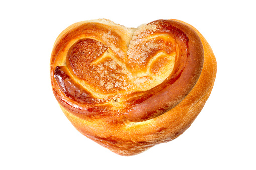 Sweet bun on white background. Bun close-up. Heart-shaped bun.