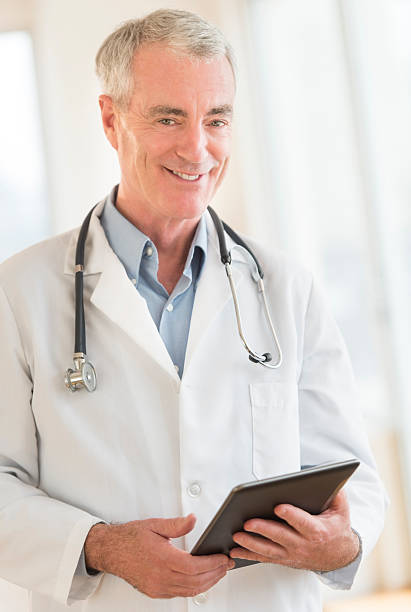 istock Confident Doctor With Digital Tablet At Clinic 186662168