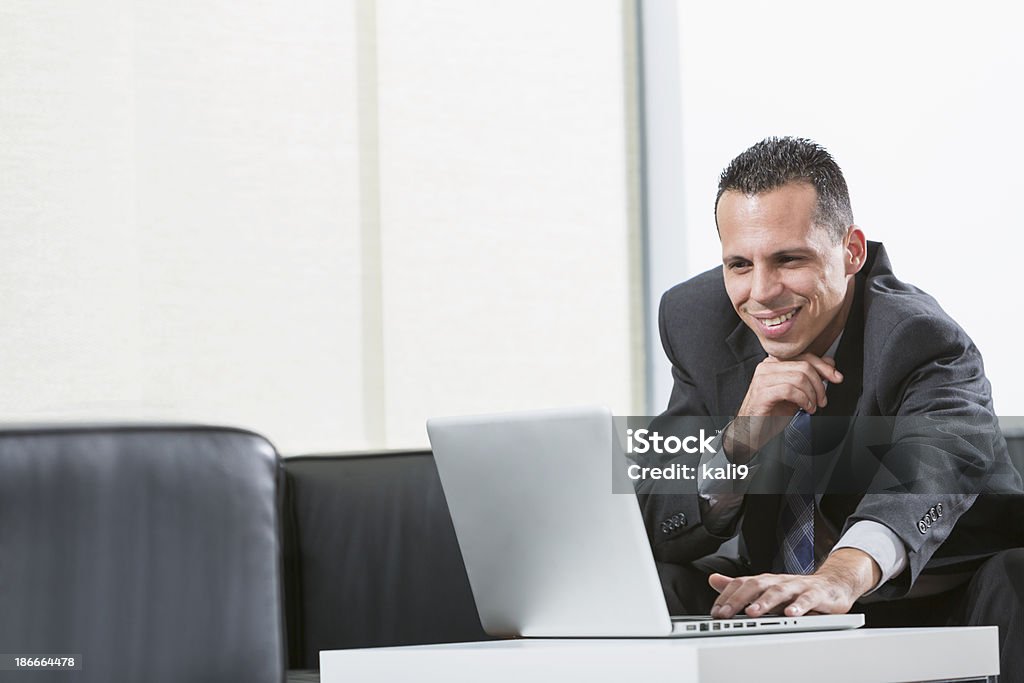 Empresario hispano usando traje de negocios usando computadora portátil - Foto de stock de Administrador libre de derechos