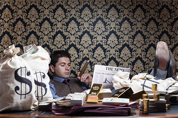 istock Wealthy man reading newspaper on desk 186664788