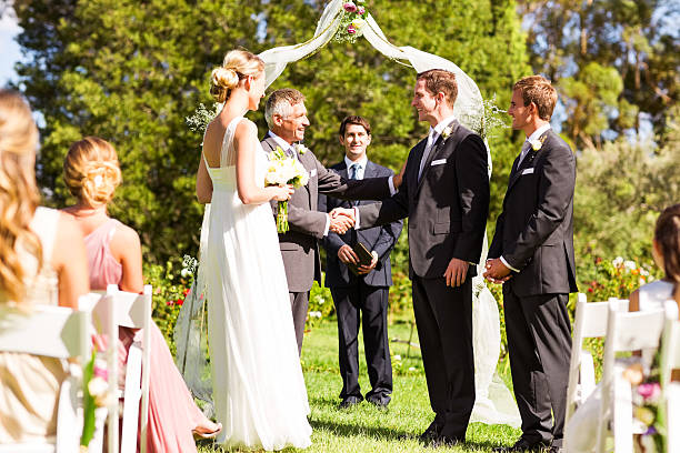 istock Father Congratulating Groom During Outdoor Wedding 186664875