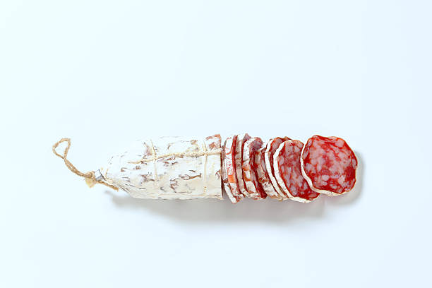french salami sliced french dried salami on white background salami stock pictures, royalty-free photos & images