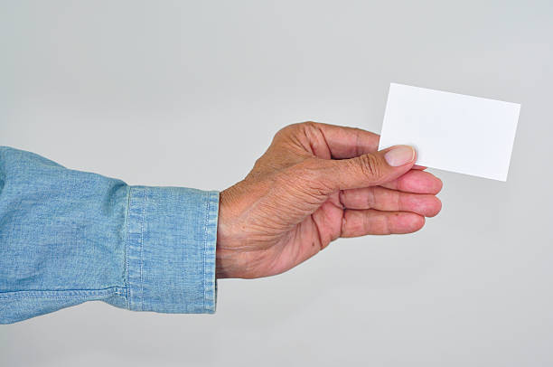 istock Senior man holding up a blank card. 186666730