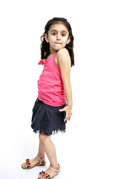 Smiling young girl posing. Full length studio shot isolated on white.