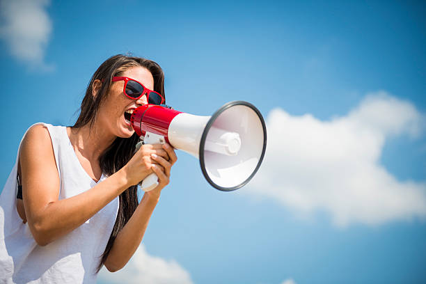Young woman with megaphone stock photo