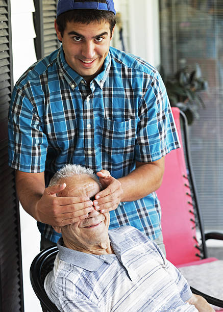 istock Grandson Covering Grandfather's Eyes 186667275