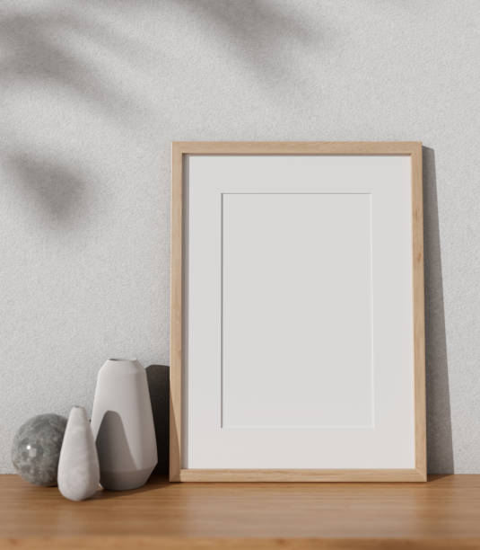istock An empty picture frame mockup, ceramic vases, and decorating stuff on a wooden desk. 1866674533
