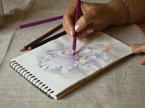 istock Artist's hand drawing an iris flower head 186667663
