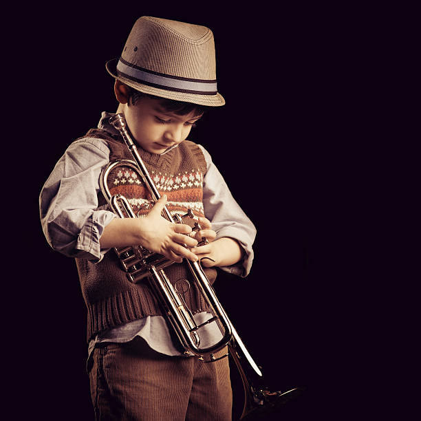 istock four years old kid with a trumpet 186668213
