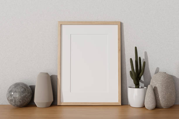 istock An empty picture frame mockup, ceramic vases, and decorating stuff on a wooden desk. 1866682365