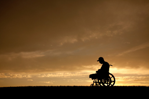 Shot of a senior man looking out of a window while sitting in a wheelchair at a home,elder asian male stay home alone in wheelchair look at view out of window from living room