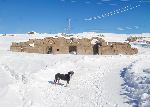 In front of the old Church in Karadag on a snow-covered Karaman morning