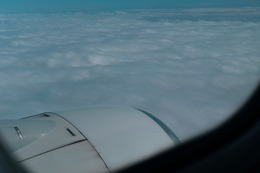 view of cloudy sky, flight in plane over clouds view from window, travelling concept
